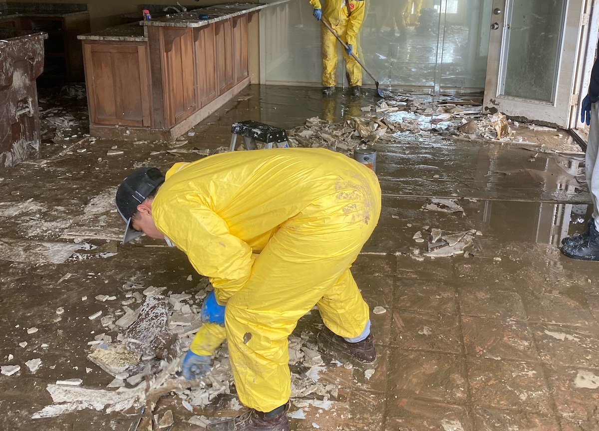 Core Restore specialists cleaning living space from flood damage.