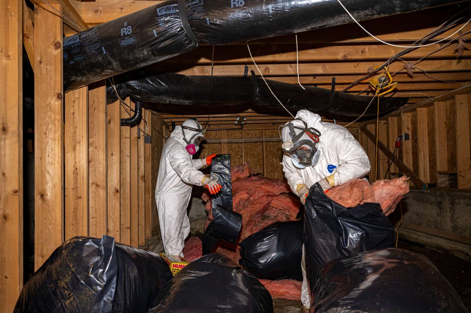 Crawlspace before cleanup showing moisture and debris buildup