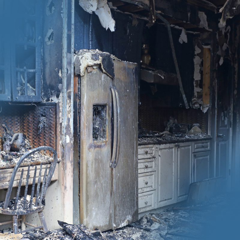 Kitchen damaged by fire showing charred surfaces