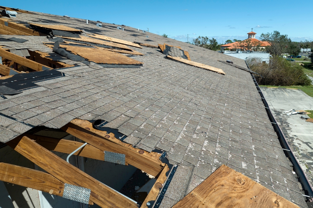 House roof damaged by disaster with missing shingles